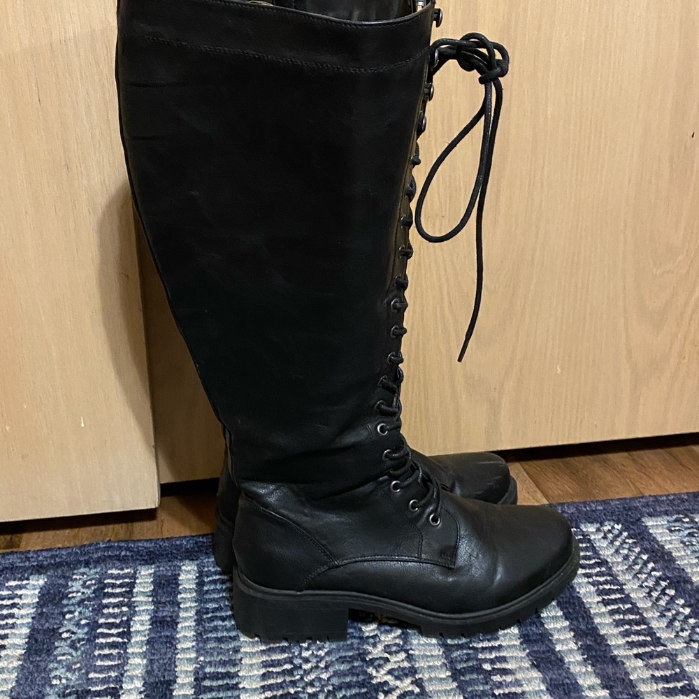 Torrid knee high combat boots.